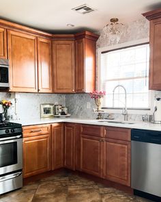 a kitchen with wooden cabinets and stainless steel appliances