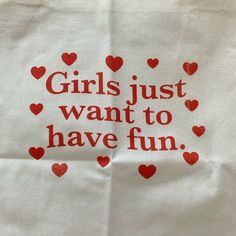 a white bag with red hearts on it that says girls just want to have fun