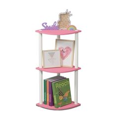 a pink shelf with books and pictures on it's sides, in the shape of a heart