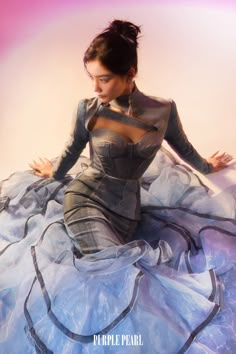 a woman sitting on top of a blue dress