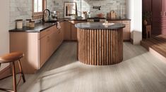 a kitchen with pink cabinets and marble counter tops, along with wooden stools in front of the island