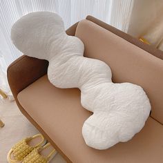 a white stuffed animal laying on top of a couch