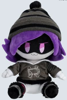 a stuffed animal wearing a beanie hat and sweater with purple eyes sitting on a white surface