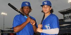 two baseball players are posing for a photo