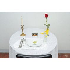 there is a small table set up with food and flowers on it for an event