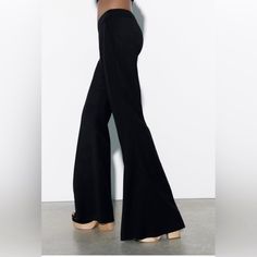 Zara Has Outdone Themselves With Their Numerous Designs Of Quintessential Black Dress Pants. This One Is A Sure Winner Because It’s Simple & Straightforward But Without Doubt A Fashion Statement. The Hidden Side Zip Closure Without Lumpy Pockets, And A Narrow High Waisted Band Ensures That It Sits Flat Against Your Waist And Flows Down Softly Into A Wide Leg, Giving You Shape And Style And Elongating Your Legs. Also It Gives You The Option To Match A Large Variety Of Boots/Stilettos/Chunky Platf Chic Tailored Zara Wide Leg Pants, Elegant Fitted Dress Pants By Zara, Elegant Fitted Zara Dress Pants, Zara High-waist Fitted Pants, Zara Tailored Wide Leg Pants, Casual Fitted Wide Leg Pants For Night Out, Zara Elegant Wide-leg Dress Pants, Elegant Zara Wide-leg Dress Pants, Elegant Straight Leg Jeans For Night Out