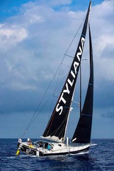 a sailboat sailing in the ocean on a cloudy day