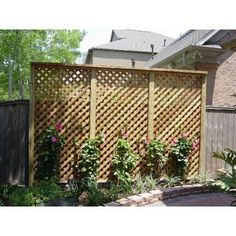 a wooden fence with flowers growing on it