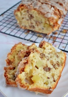 two slices of banana bread sitting on top of a white plate next to a cooling rack