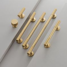 brass handles and knobs on a gray surface