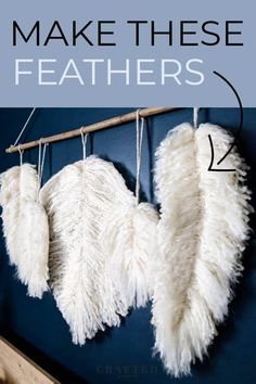 two white feathers hanging on a wall with text overlay that reads make these feathered curtains