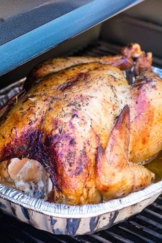 a roasted turkey sitting in an oven with the words smoked turkey on it's side