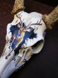 an animal's skull with antlers on it is shown in this image, which appears to have been painted