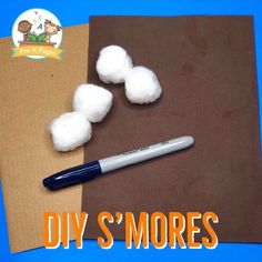 some cotton balls and a pen sitting on top of a piece of brown paper with the words diy's'mores