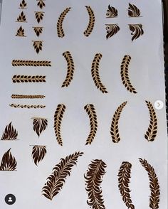 various designs on a sheet of paper that is being cut into smaller shapes and sizes