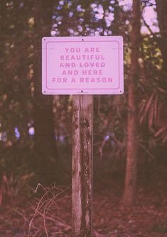 a pink sign that says you are beautiful and loved and here for a reason