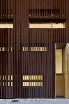 an open door on the side of a building that has wooden slats covering it