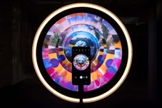 a phone is sitting in front of a circular object that looks like a spinning wheel