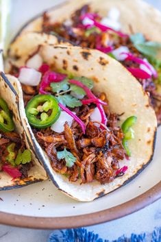 two tacos on a plate with the text crispy and flavorful vegan cantass with mushrooms