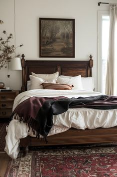 a bedroom with a bed, dresser and rug