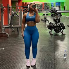 a woman taking a selfie in the gym