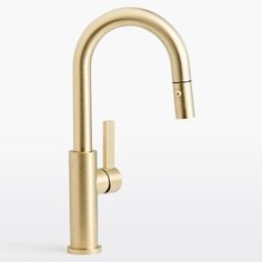 a gold faucet with the handle extended to it's side spout