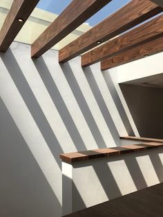 an empty room with wooden stairs and white walls