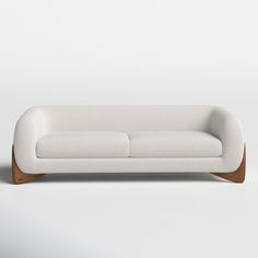 a white couch sitting on top of a wooden frame