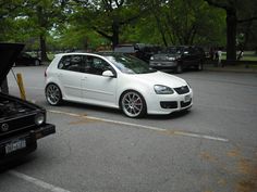 a white car is parked in the parking lot