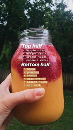 a person holding up a jar with some fruit in it's top half and bottom half