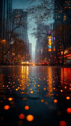 a city street at night with lights reflecting in the water