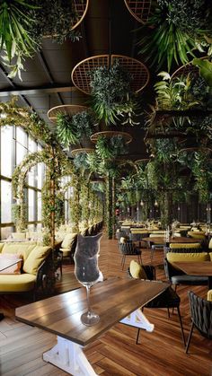 the interior of a restaurant with plants hanging from the ceiling