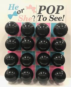 there are many black balls in the shape of smiley faces on a pink and blue checkered board