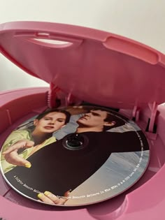 the dvd case is pink and has two pictures on it, as well as an open lid