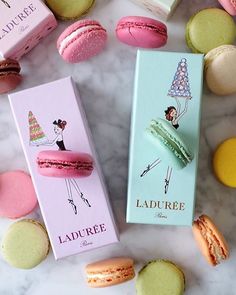 two macaroons are sitting next to each other on a marble surface with the caption ladureee