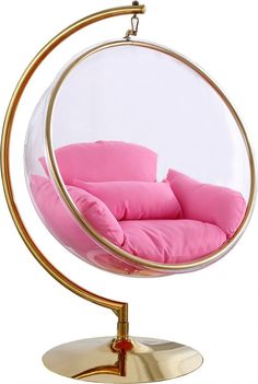 a pink chair in a glass ball on a metal stand with a gold plated base