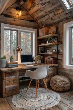 a home office with wooden walls and flooring in the corner, along with two windows