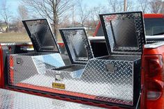 the back end of a pickup truck with three flatbeds on it's bed