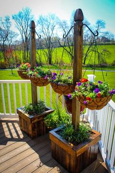 two planters with flowers are on the porch