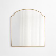 a gold framed mirror against a white wall