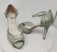 a pair of green high heeled shoes on display