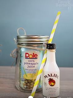 a bottle of pineapple juice next to a mason jar