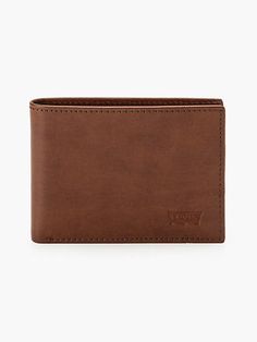 Timeless style, organizational functionality and the quality Levi's® is known for;together in a leather bifold wallet with ID window. This handy essential is embossed with our iconic batwing logo. Features 6 card pockets and a slip pocket for cash Crafted from 100% leather for long-lasting quality and wear Embossed Levi's® batwing logo on the front Cheap Brown Bifold Wallet, Modern Brown Bifold Wallet, Vintage Brown Bifold Wallet, Mens Leather Wallet Bifold, Luxury Brown Bifold Wallet, Id Wallet, Leather Bifold Wallet, Wallet Men, Timeless Fashion