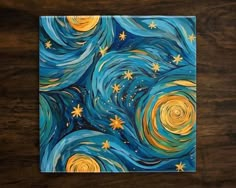 a painting with stars and swirls painted on the surface in blue, yellow and white