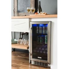 a wine cooler with bottles and glasses in it