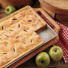 an apple pie sitting on top of a wooden table