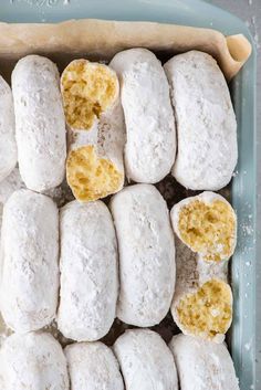 there are several doughnuts that have been cut in half and placed on a baking sheet