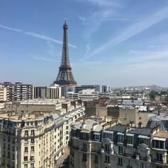 the eiffel tower towering over paris, france is seen from an apartment building