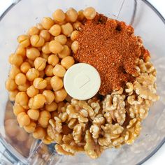 ingredients in a food processor ready to be blended into something else for the recipe, including chickpeas and seasoning