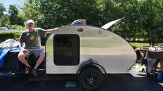 a man and woman sitting in the back of a trailer